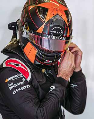 Formula E racer adjusting helmet